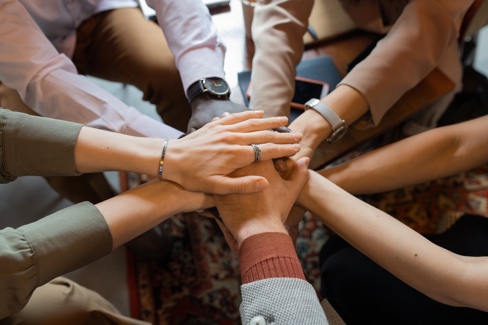 Pile of hands of several intercultural colleagues